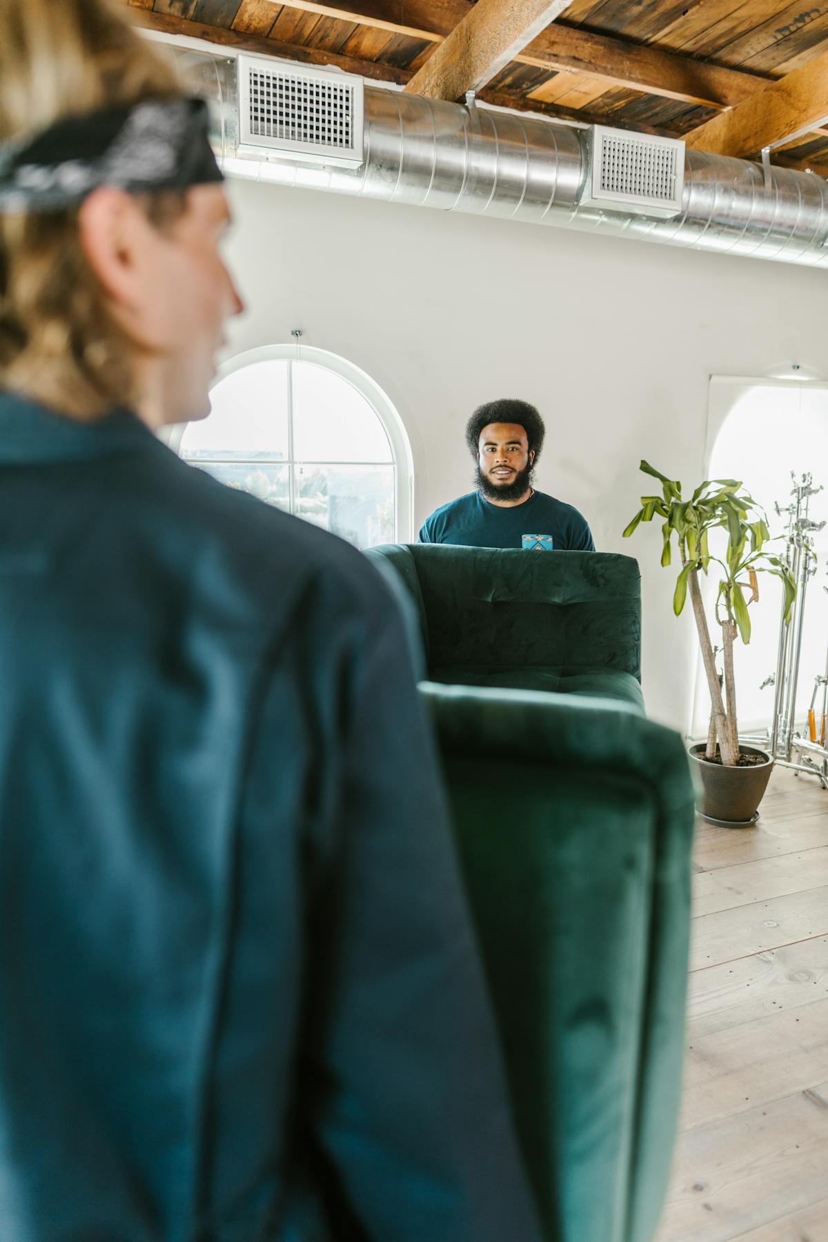 Movers carrying a sofa into a home